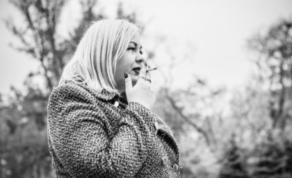 Black-and-white photograph of woman smoking.